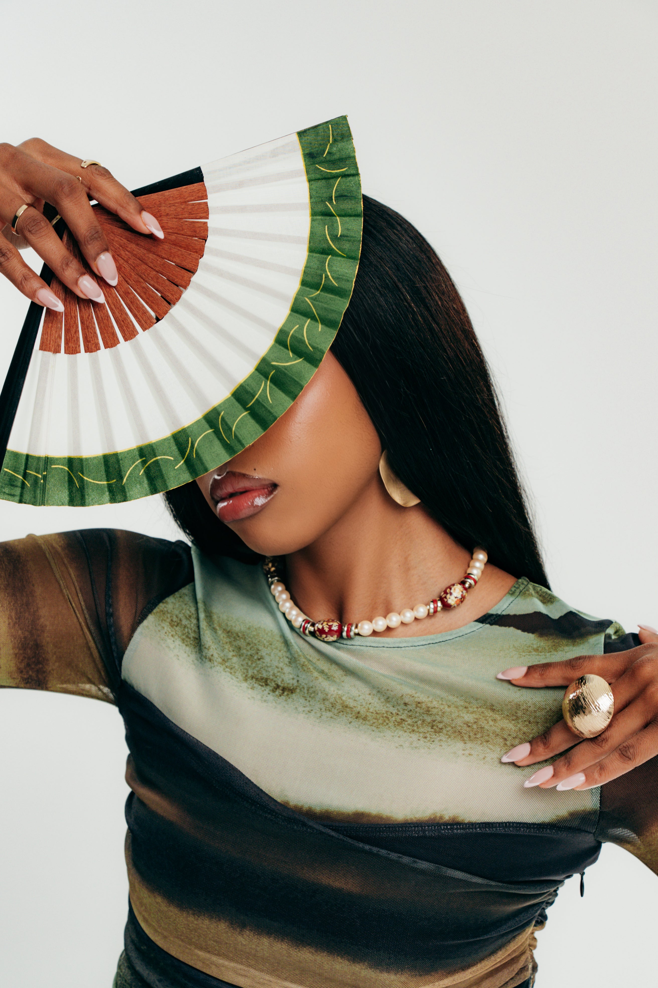 Woman holding a fan with a white background